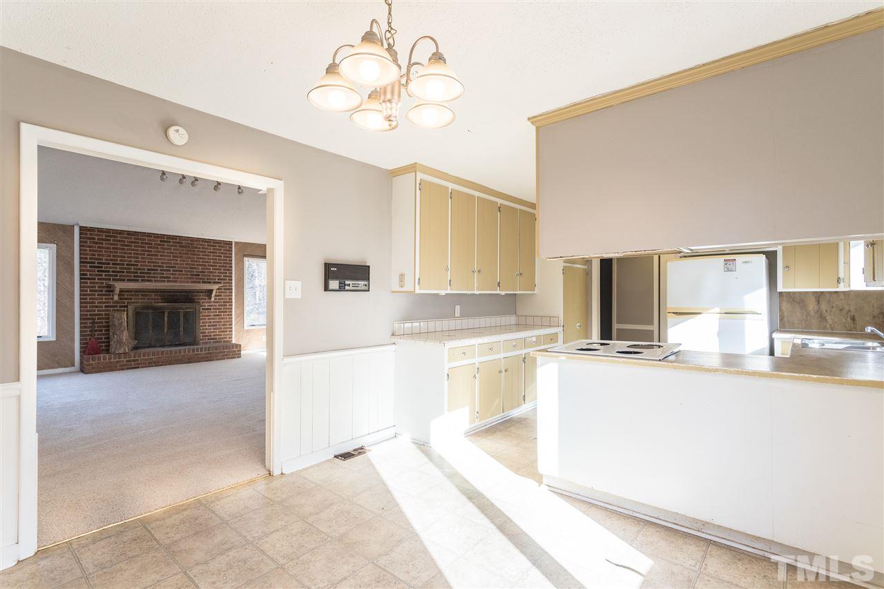 2004 Brocton Place Durham, NC 27712 - Photo 8 of 29 a large white kitchen with a sink and dishwasher a stove top oven with wooden floor