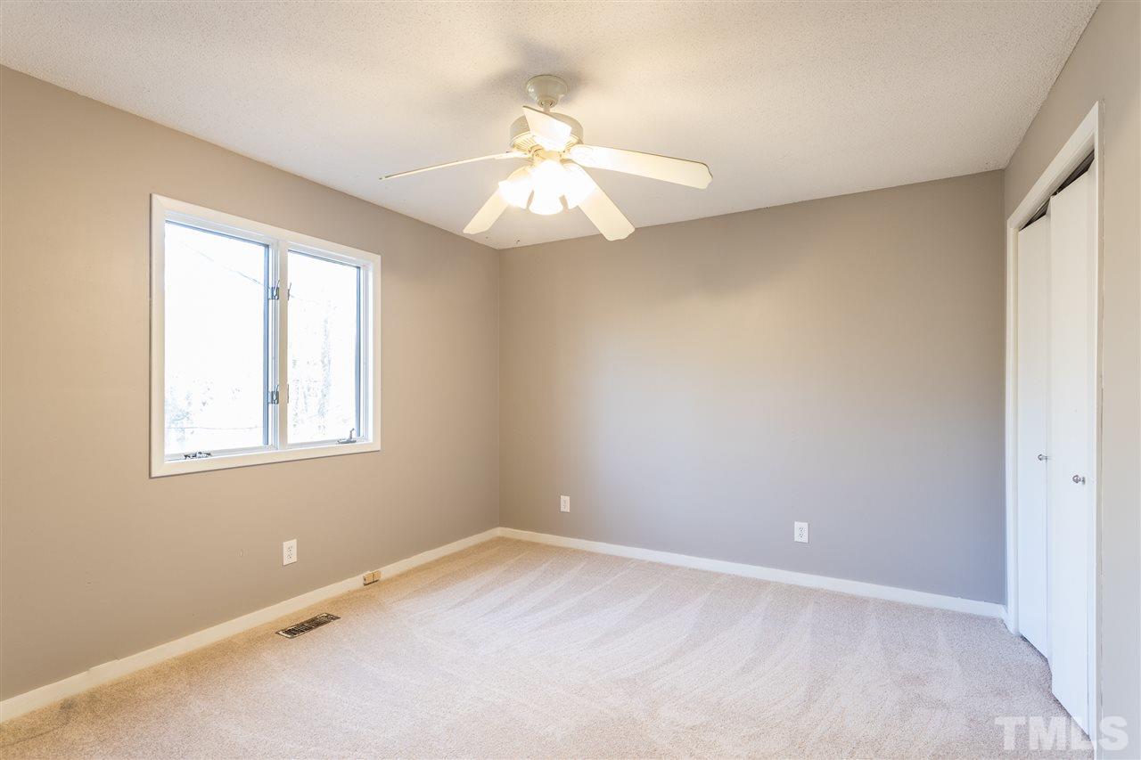 2004 Brocton Place Durham, NC 27712 - Photo 10 of 29 an empty room with a window and a chandelier fan