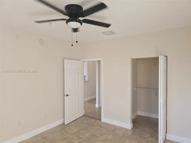a view of a hallway with a chandelier fan