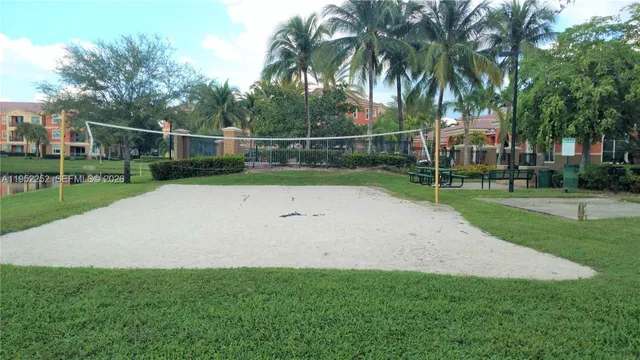 a view of a garden with a fence and a tree