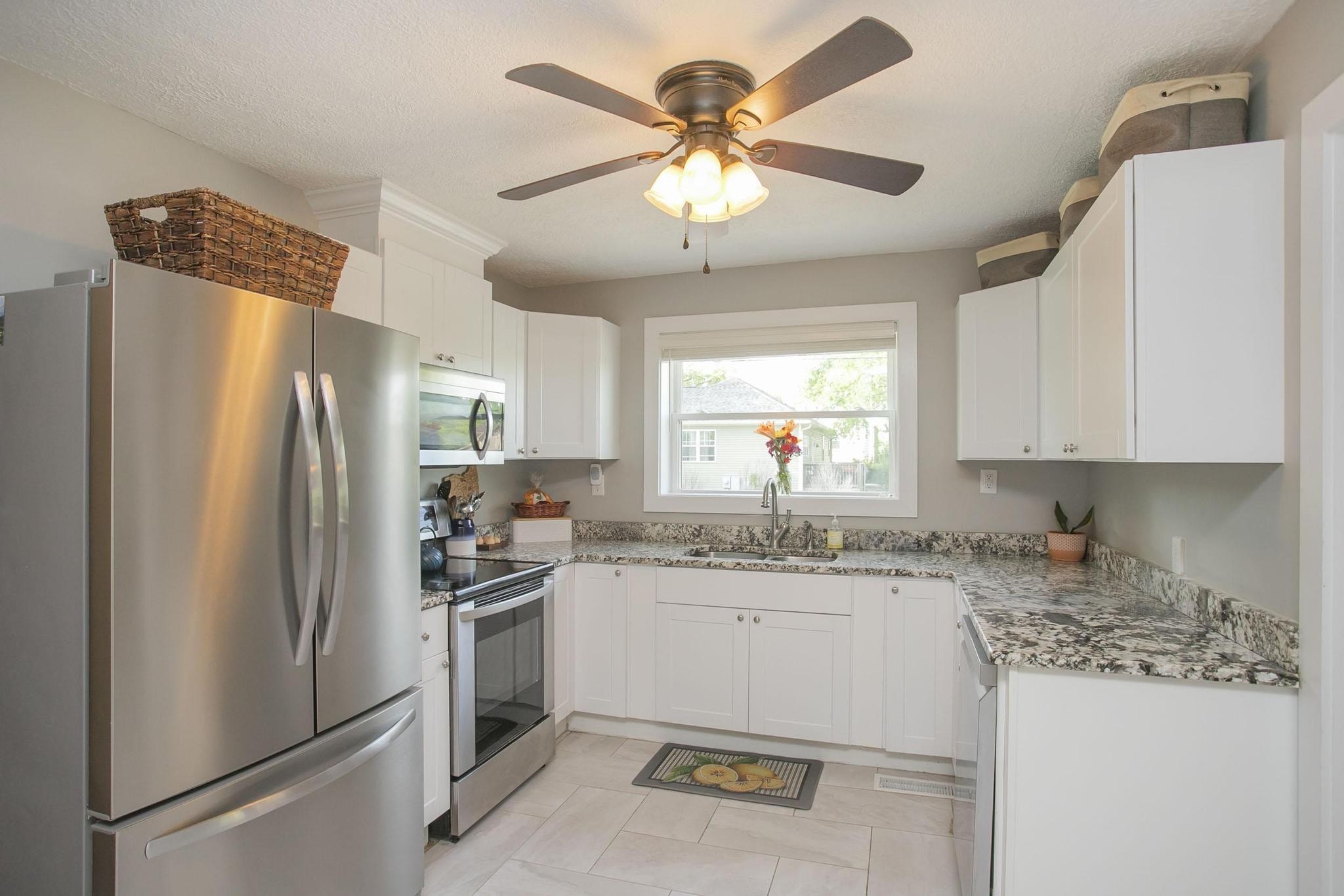 806 Fleming Street Columbia, TN 38401 - Photo 15 of 54 a kitchen with a sink a refrigerator a stove and white cabinets