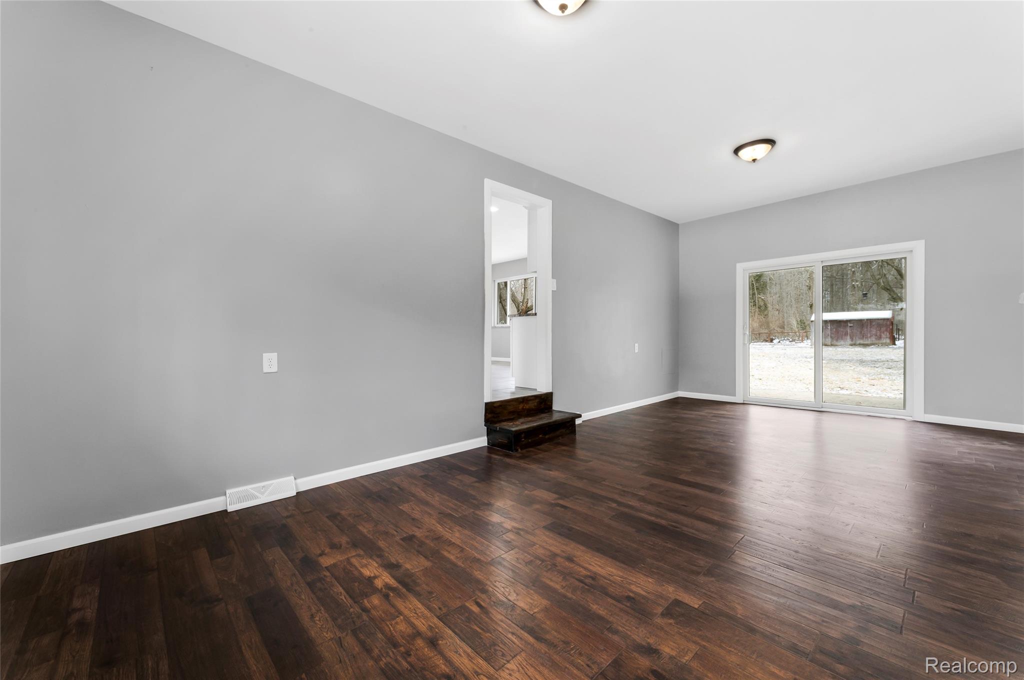 13515 Lenmoore Road Belleville, MI 48111 - Photo 17 of 41 Unfurnished room with dark wood-type flooring, Dining and family room.