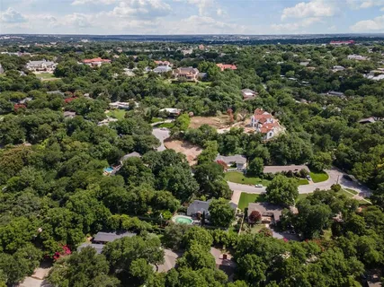 a view of a backyard with large trees