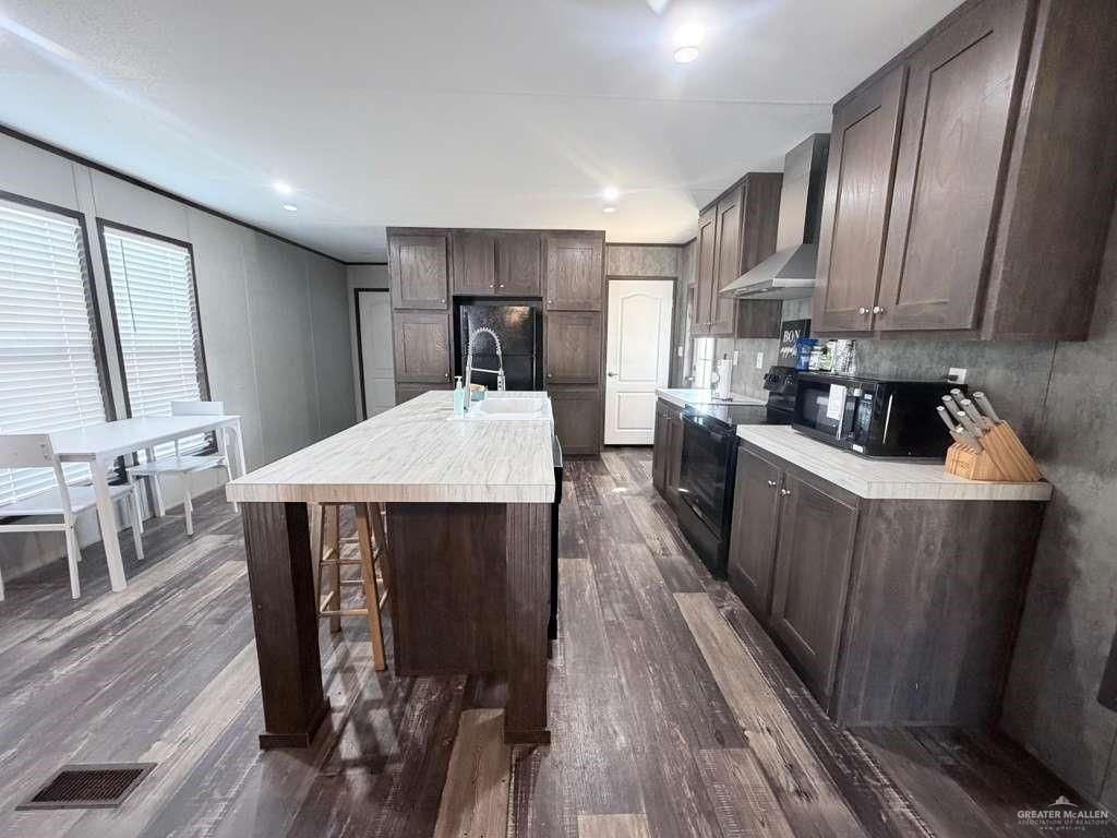 8511 Western Road Mission, TX 78574 - Photo 4 of 15 a kitchen with stainless steel appliances a dining table chairs stove refrigerator and cabinets