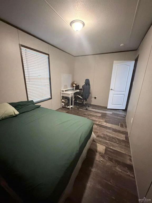 8511 Western Road Mission, TX 78574 - Photo 10 of 15 a bedroom with a bed and a mirror