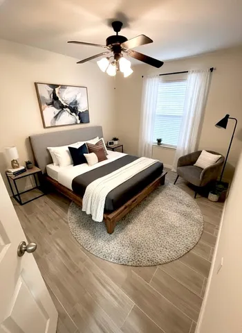 a bedroom with bed and a chandelier