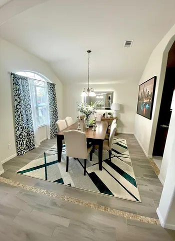 a view of a dining room with furniture window and wooden floor