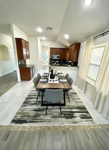 a living room with furniture and a rug