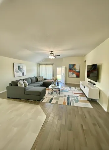 a living room with furniture and a flat screen tv