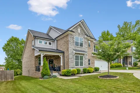 a view of a house with a backyard