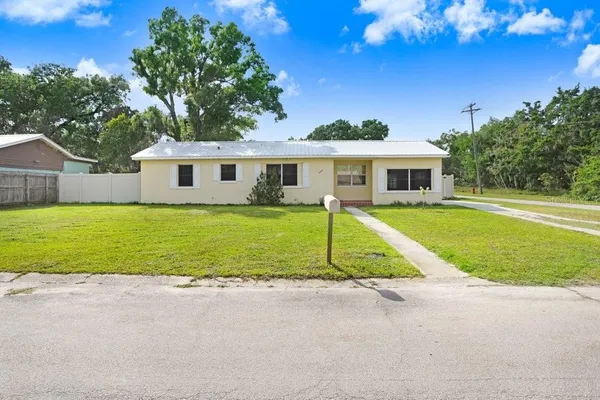 a front view of house with yard and green space