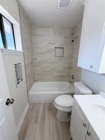 a bathroom with a toilet a sink and a bathtub