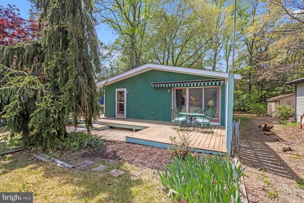 a front view of a house with a yard outdoor seating and garage