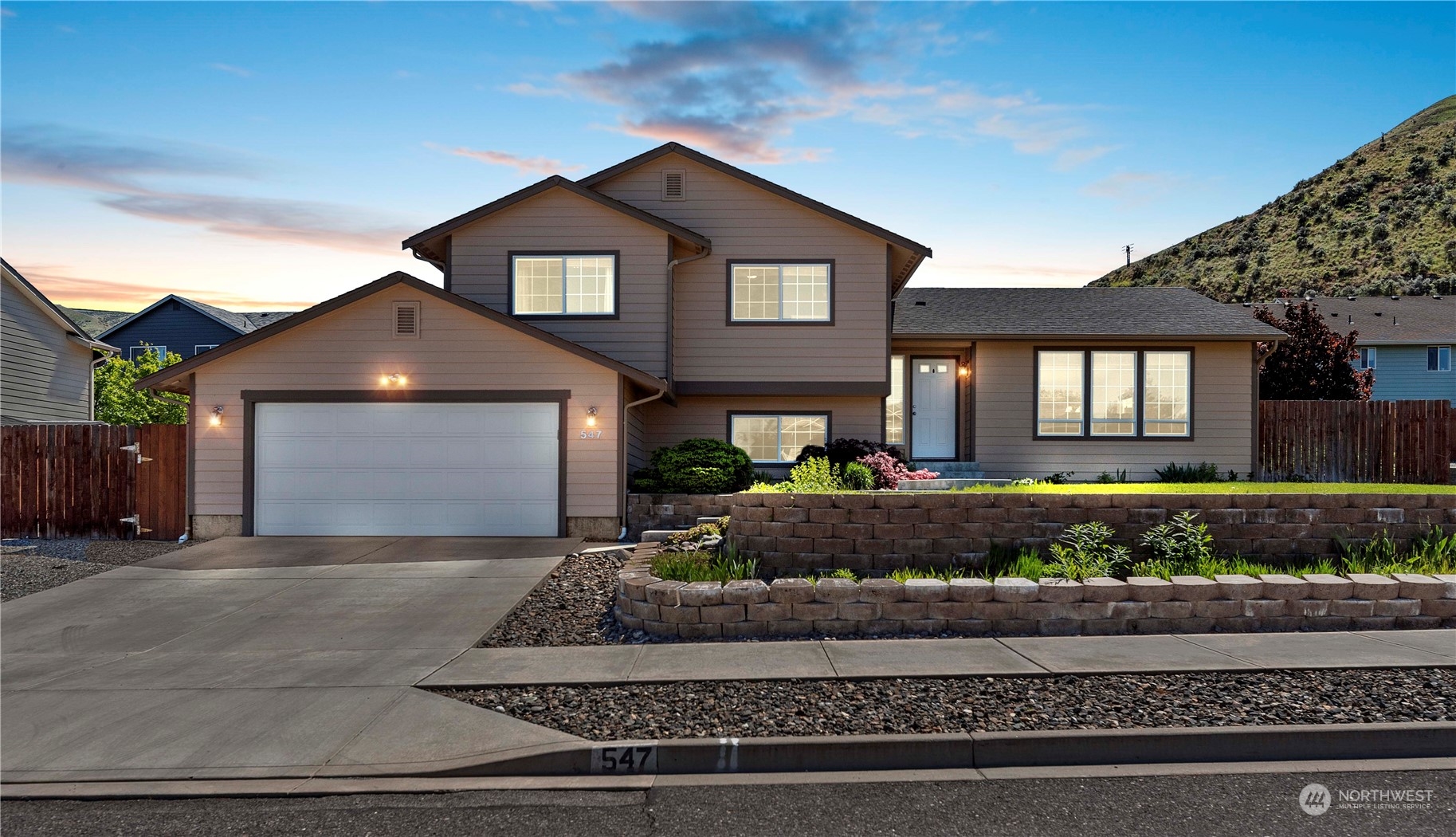 a front view of a house with a yard and garage