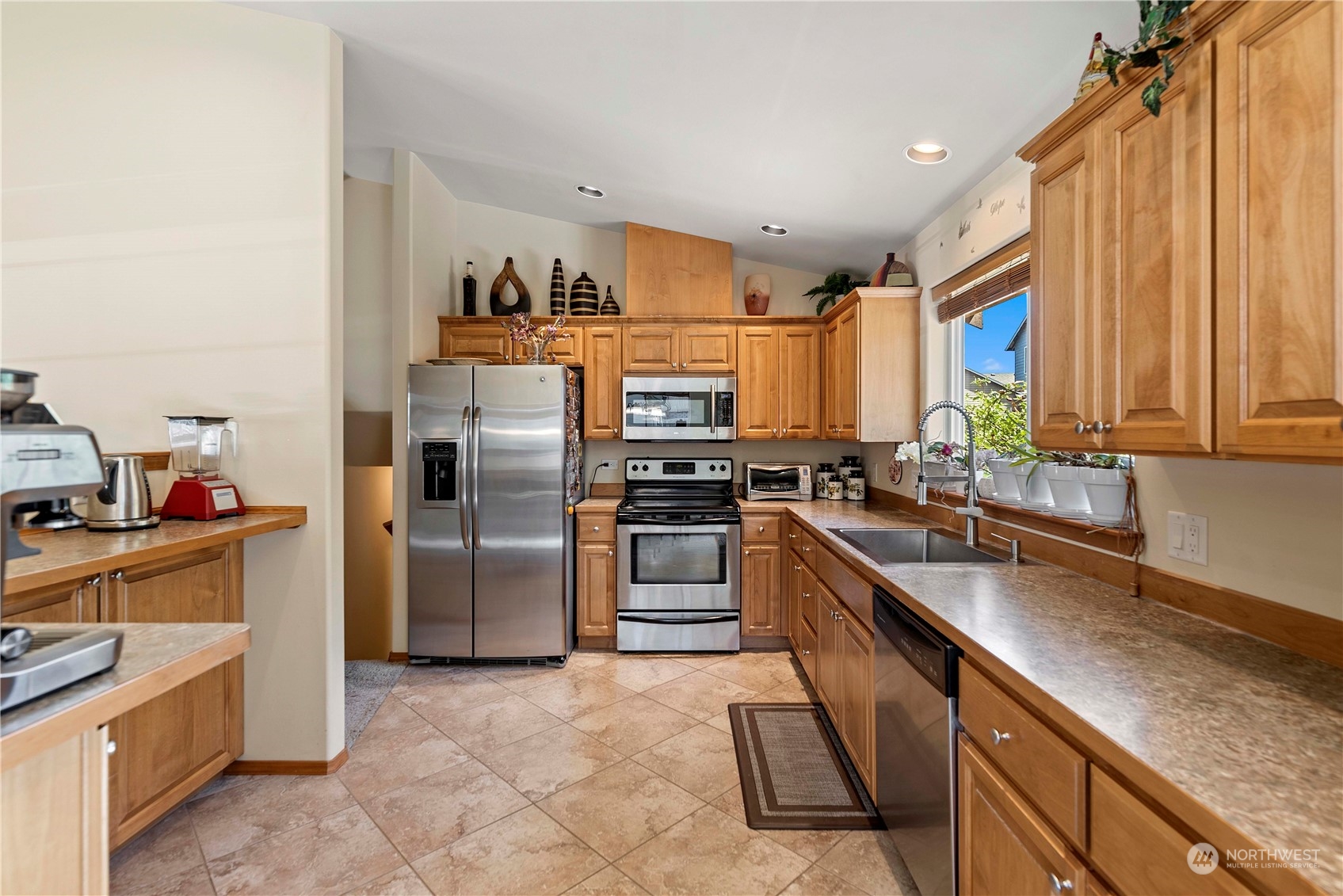 547 Saddle Rock Loop Wenatchee, WA 98801 - Photo 11 of 36 a kitchen with stainless steel appliances granite countertop a refrigerator and a sink