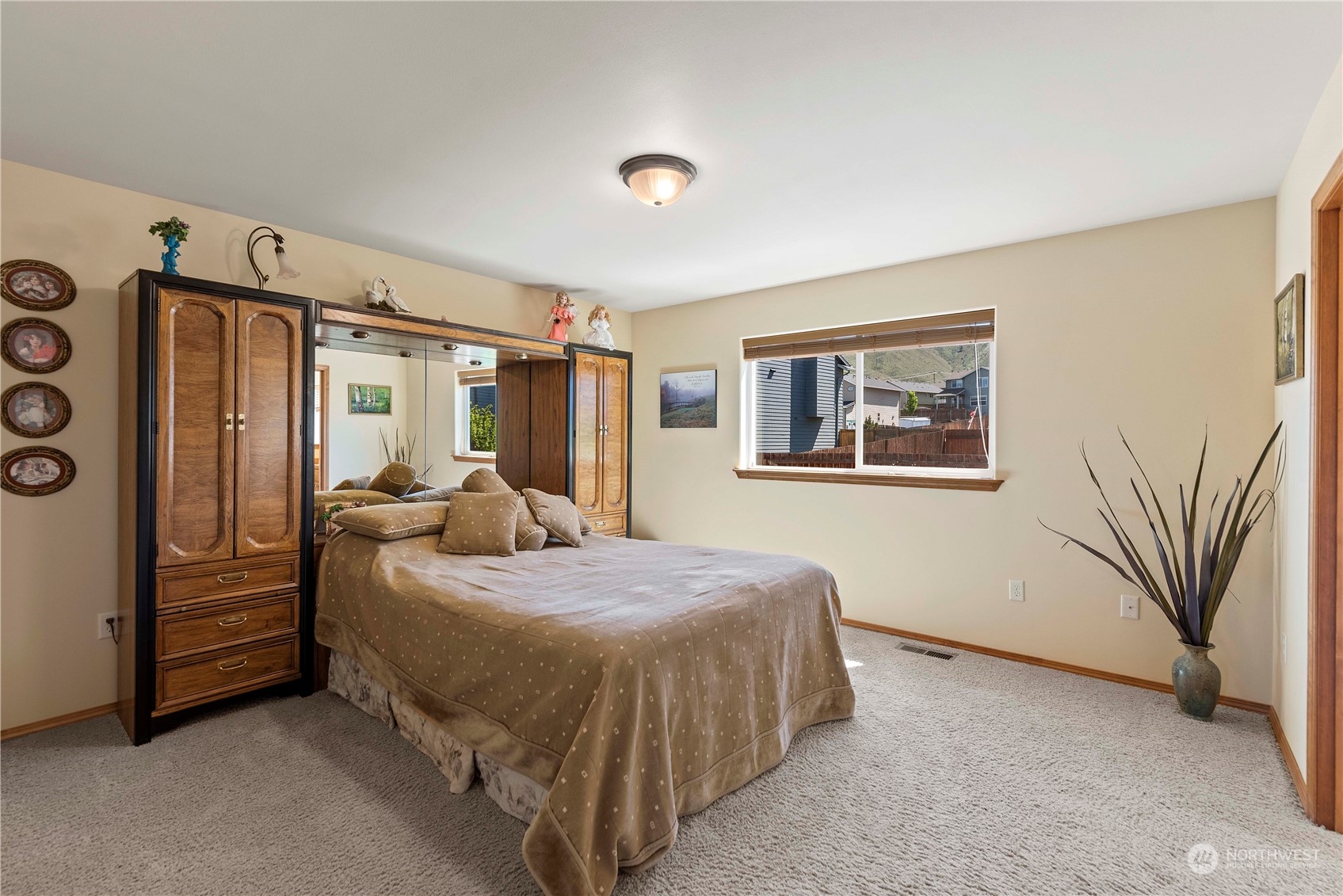 547 Saddle Rock Loop Wenatchee, WA 98801 - Photo 17 of 36 a bedroom with a bed dresser and a window