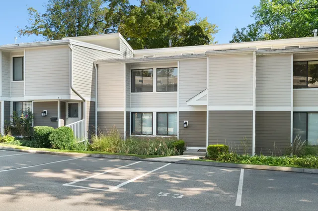 a front view of a house with a yard and a garage