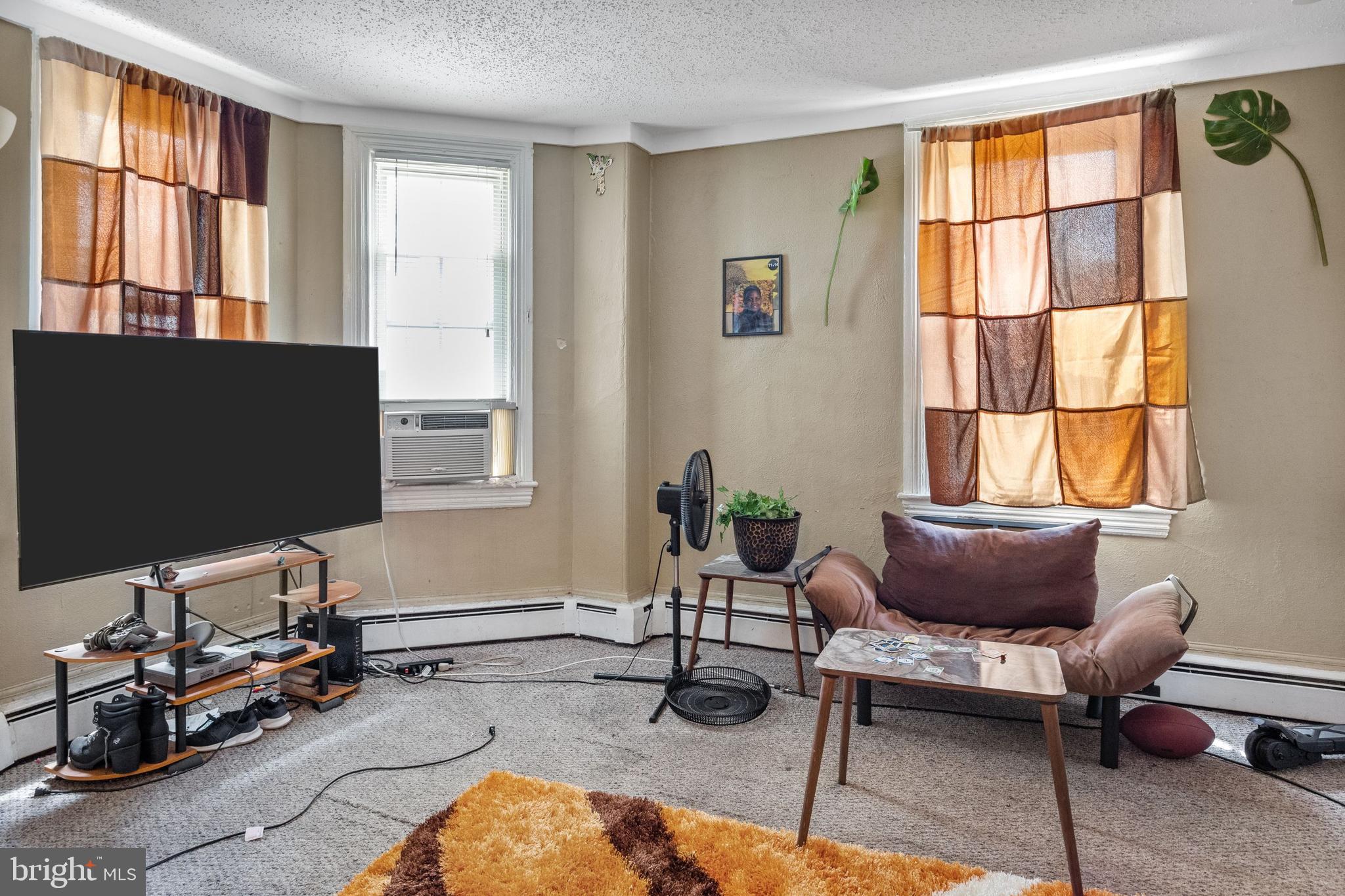 250 Washington Street Morrisville, PA 19067 - Photo 11 of 27 a living room with furniture a flat screen tv and a window