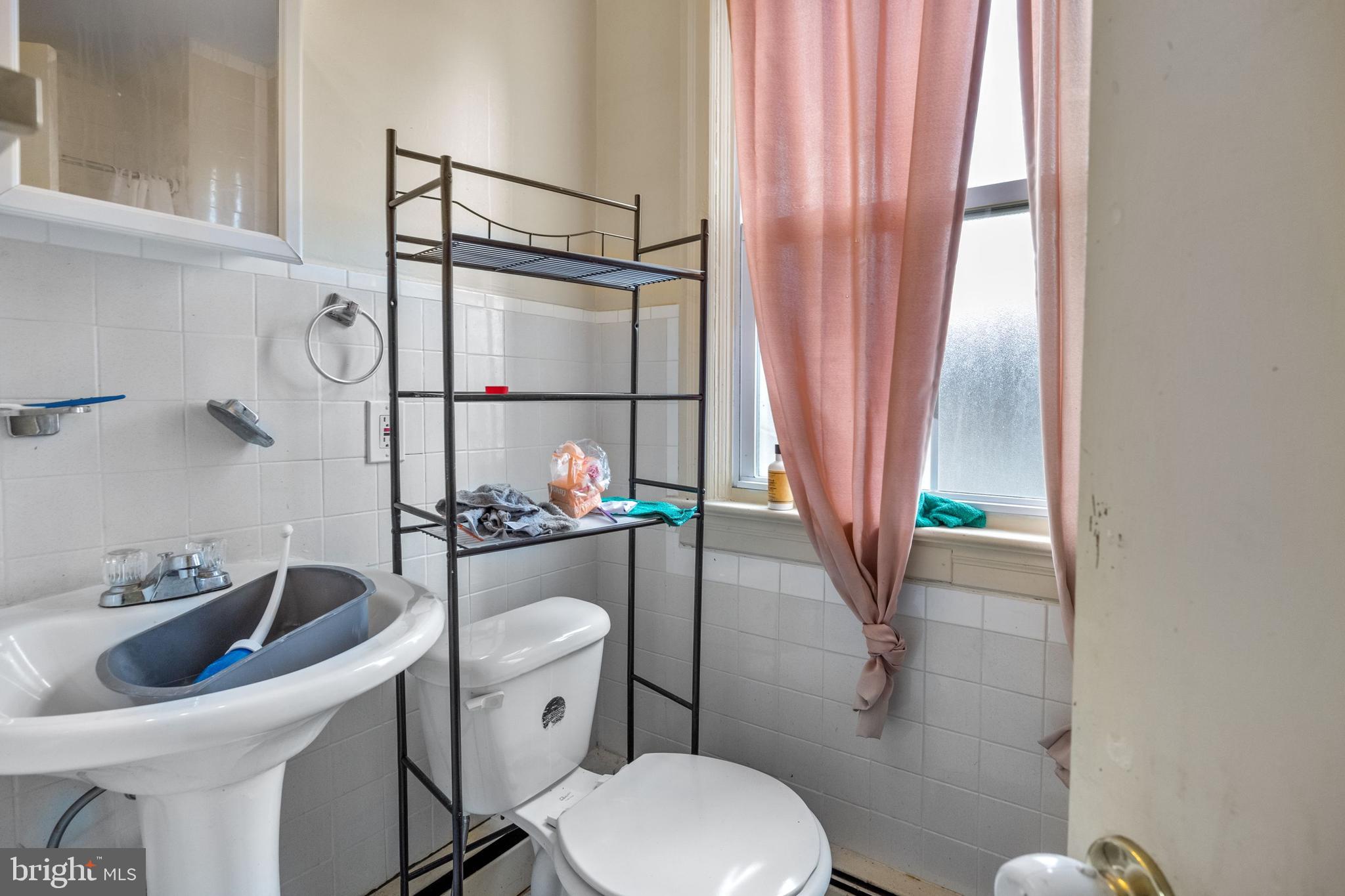 250 Washington Street Morrisville, PA 19067 - Photo 23 of 27 a bathroom with a toilet sink and mirror
