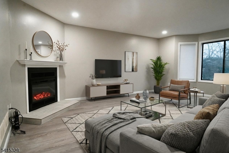 148 Nottingham Square Hackettstown, NJ 07840 - Photo 2 of 15 a living room with furniture a fireplace and a flat screen tv