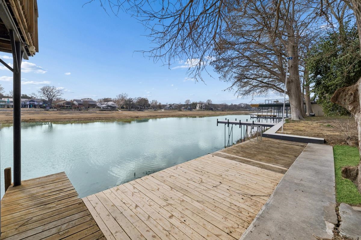 1307 Terminal Loop Road McQueeney, TX 78123 - Photo 12 of 23 a view of wooden deck and lake with trees in the background