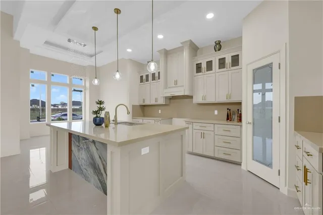 a kitchen with kitchen island a sink stainless steel appliances and cabinets