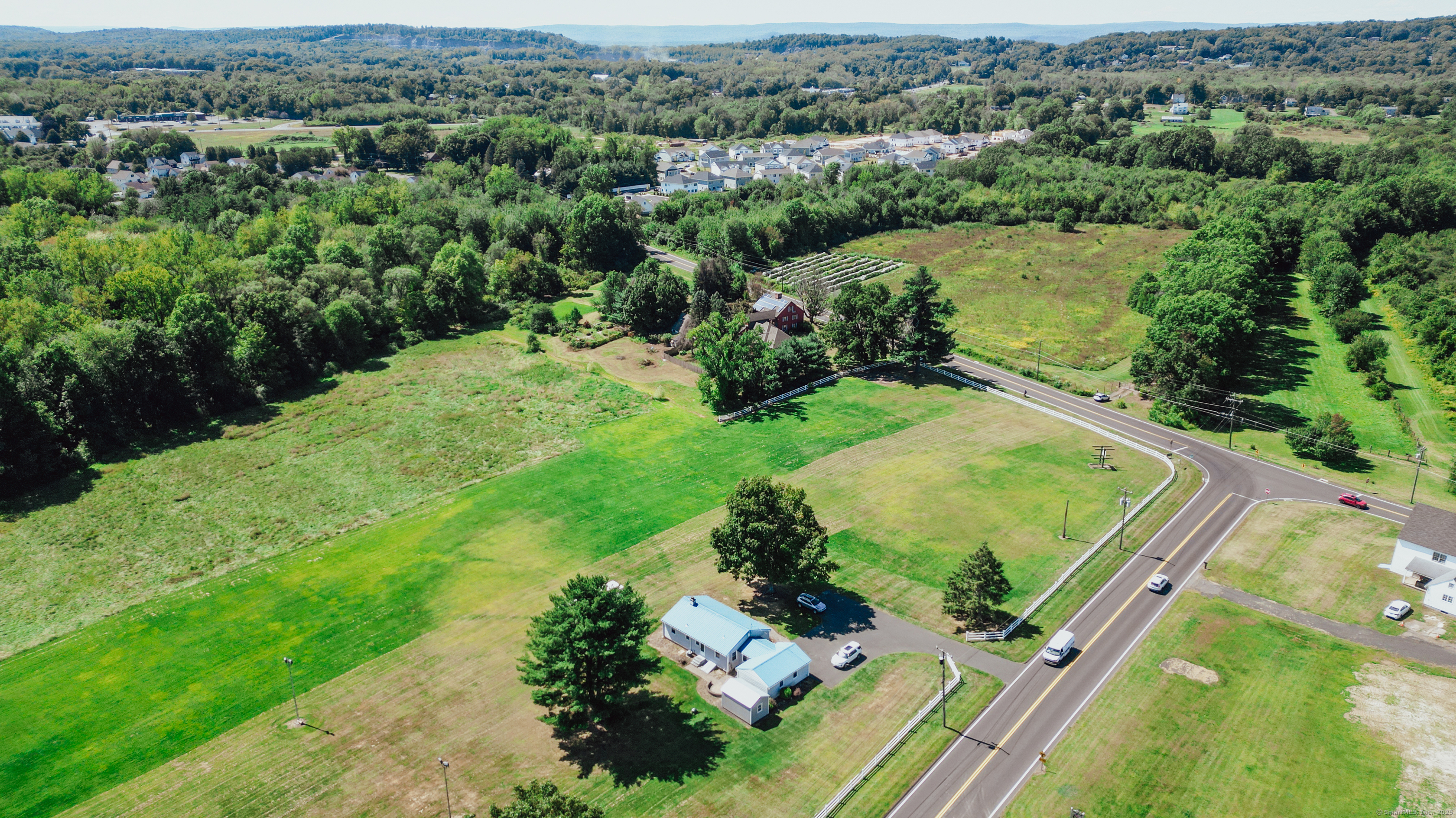 10 Russell Road East Granby, CT 06026 - Photo 6 of 30 an aerial view of green landscape with trees houses and mountain view