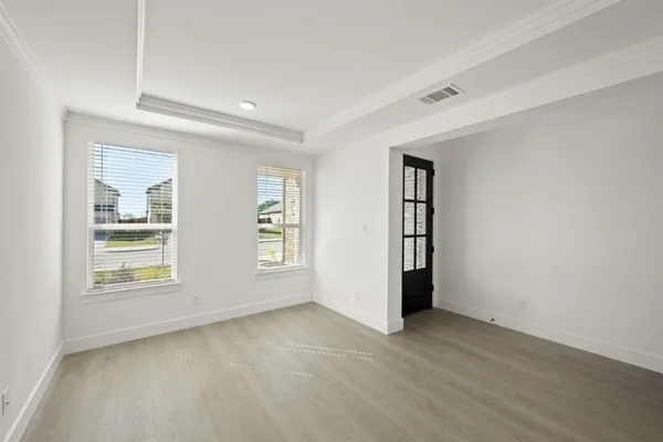 an empty room with windows and closet