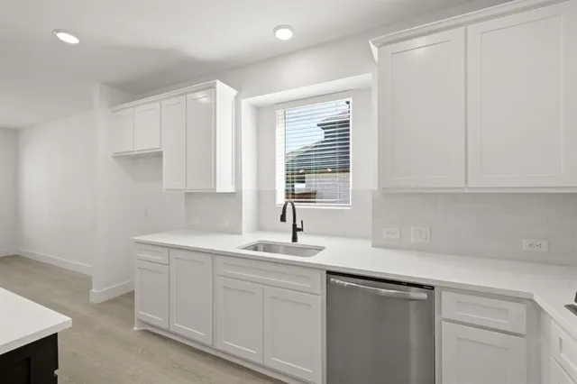 a kitchen with a sink cabinets and window