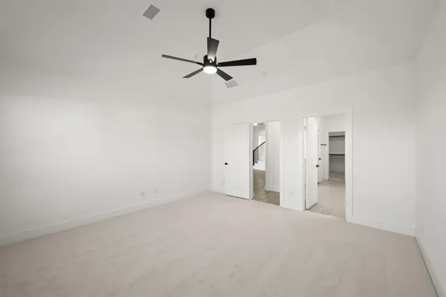 a view of a room with a stylish ceiling fan