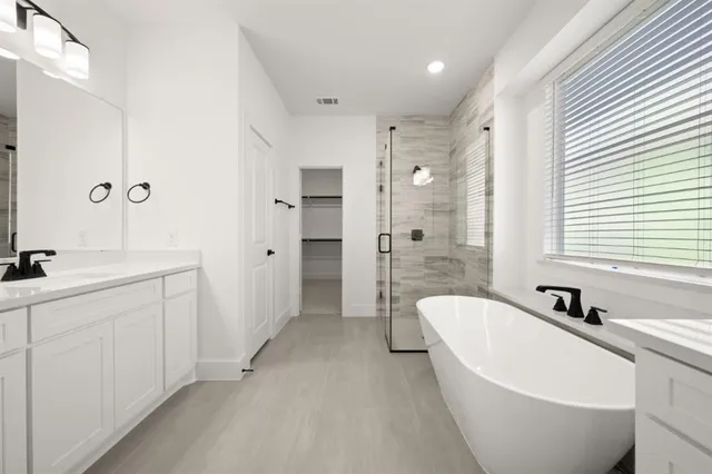 a spacious bathroom with sink shower and bathtub