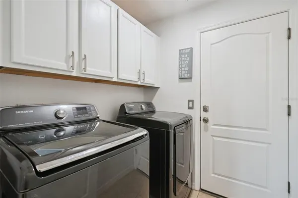 a view of a livingroom with furniture and floor to ceiling window