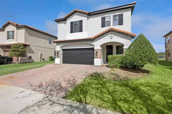 a living room with stairs and a wooden floor