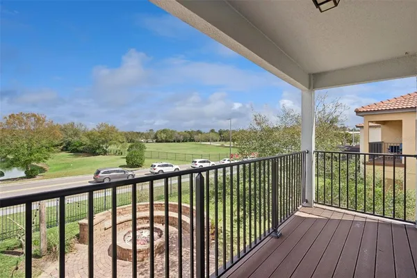 a view of a house with swimming pool and porch with furniture