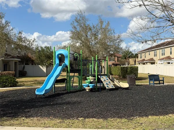 a view of a park with swings and slides