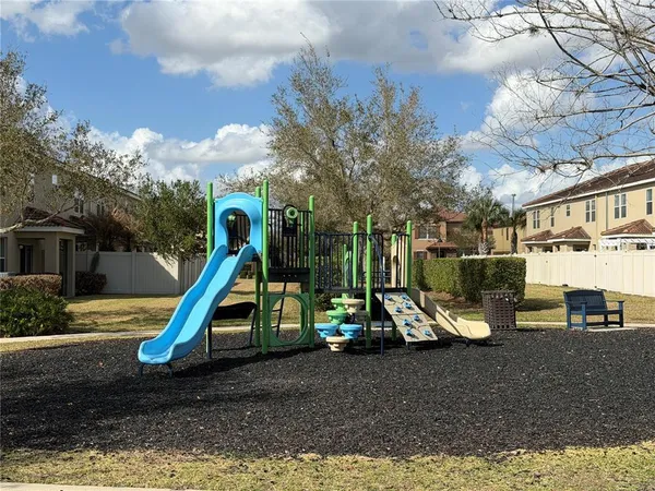 a view of a park with swings and slides