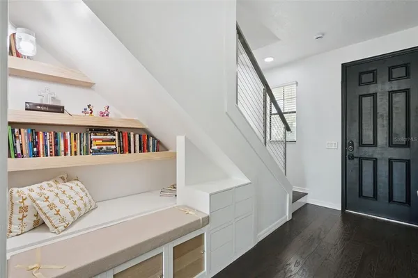 a living room with furniture and kitchen view