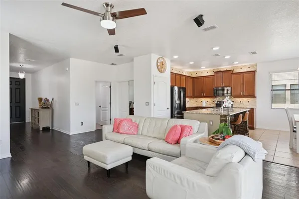 a living room with furniture windows and wooden floor