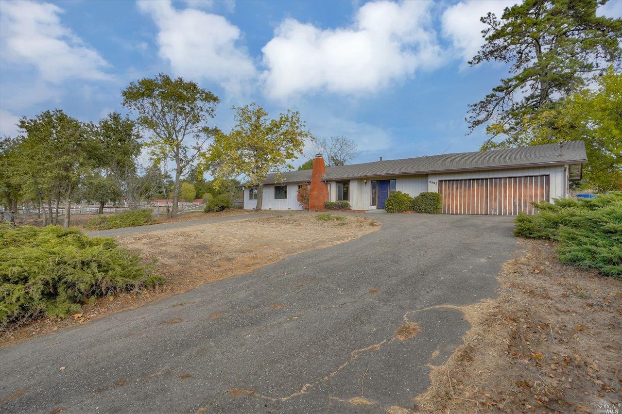 a view of house with outdoor space and trees