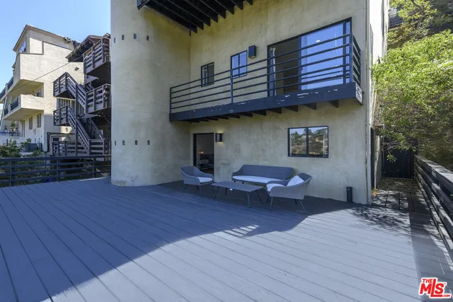 a view of house with wooden floor and outdoor seating