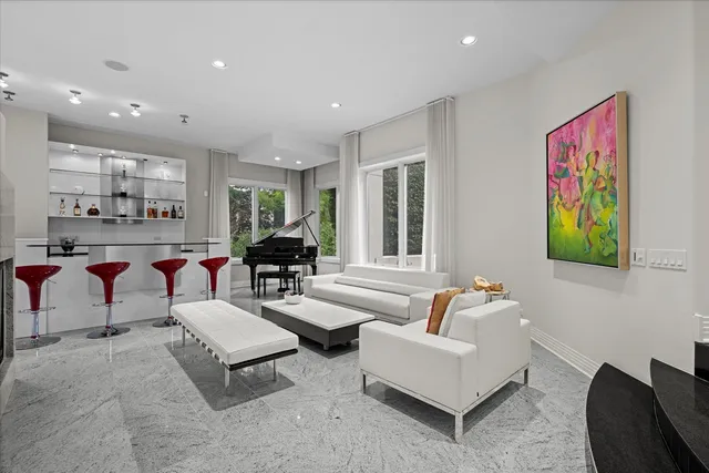 a living room with furniture and floor to ceiling windows