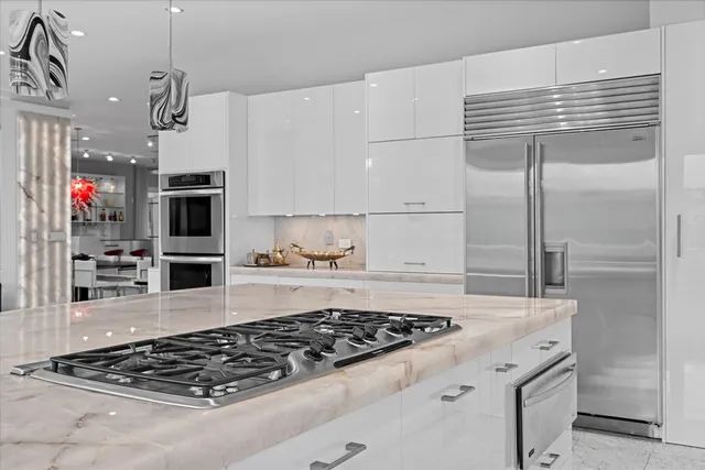 a kitchen with a stove and a refrigerator