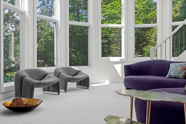 a spacious bedroom with a bed and a large window