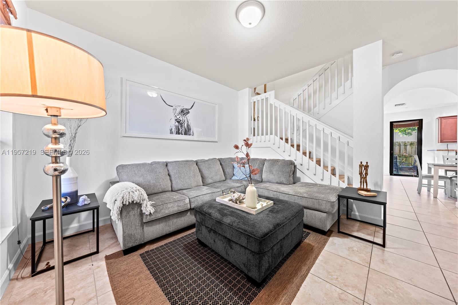 11734 Southwest 238 Street Homestead, FL 33032 - Photo 2 of 28 a living room with furniture and a chandelier