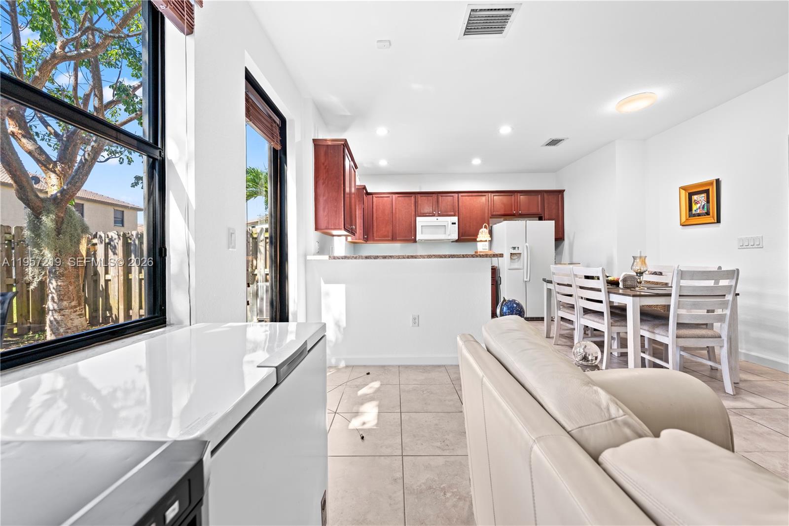 11734 Southwest 238 Street Homestead, FL 33032 - Photo 7 of 28 a living room with stainless steel appliances furniture a rug and a kitchen view