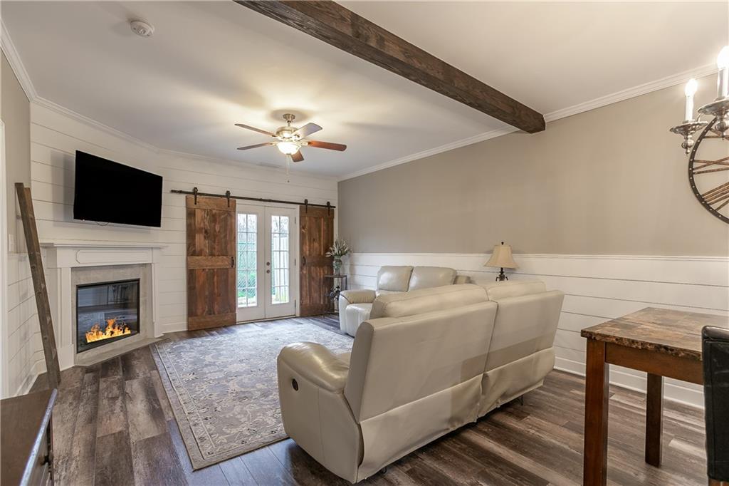 2875 Fox Wood Lane Gainesville, GA 30504 - Photo 11 of 24 a living room with furniture a fireplace and a flat screen tv