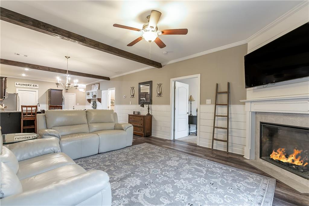 2875 Fox Wood Lane Gainesville, GA 30504 - Photo 12 of 24 a living room with furniture a flat screen tv and a fireplace