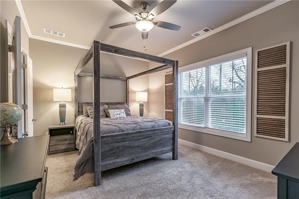 2875 Fox Wood Lane Gainesville, GA 30504 - Photo 13 of 24 a bedroom with a bed and a chandelier