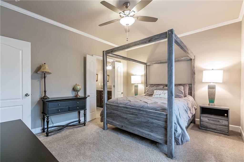 2875 Fox Wood Lane Gainesville, GA 30504 - Photo 14 of 24 a bedroom with a bed and a chandelier