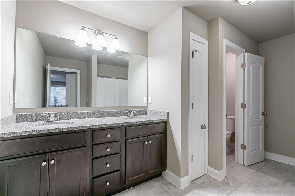 2875 Fox Wood Lane Gainesville, GA 30504 - Photo 21 of 24 a bathroom with a double vanity sink and a mirror